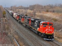 Racing ahead of a mid April snow squall, CN 8954, IC 2720, and CN 5701 lead grain train 874 through Lovekin. 1435hrs.