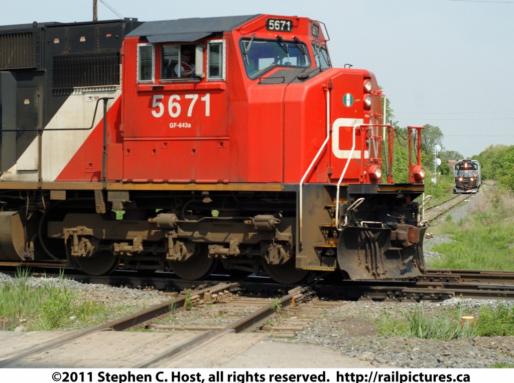 CN 5671 crosses the Diamond with Cando\'s Orangeville Brampton Railway, while the OBRY train with CCGX 1000 waits at the home signal to proceed southward.
