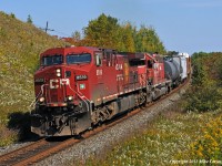 Nearing the crest of the climb west out of Port Hope, CP 8519 and DME 6096 have 235's train well in hand at Wesleyville. 1314hrs.