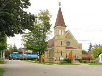 GEXR 431 makes its way past a local church.