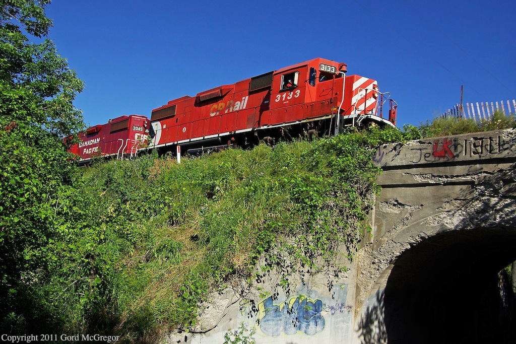 3133 is seen crossing a crumbling early century bridge at Westney Rd.1 of 3 on the Havelock Sub dated 1911 the other 2 are located in Green River and in the backwoods near Balsam over the former 6th concession.