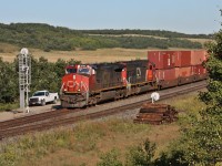 CN 116 with IC 2719 and CN painted IC 1008 haul a long intermodal by Uno where a hot box detector would stop them.