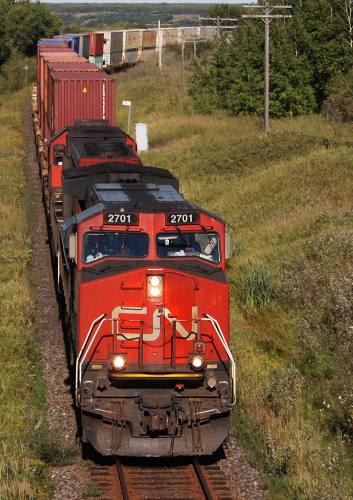 CN Q116 with IC 2701 slowly move this 145 car intermodal up hill with a bad wheel that was reported ready to come off.