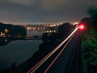 After meeting an NS Detour train at Snake, CN 903\'s DPU marker and dim headlight snakes through Bayview for the trip to Niagara Falls. 