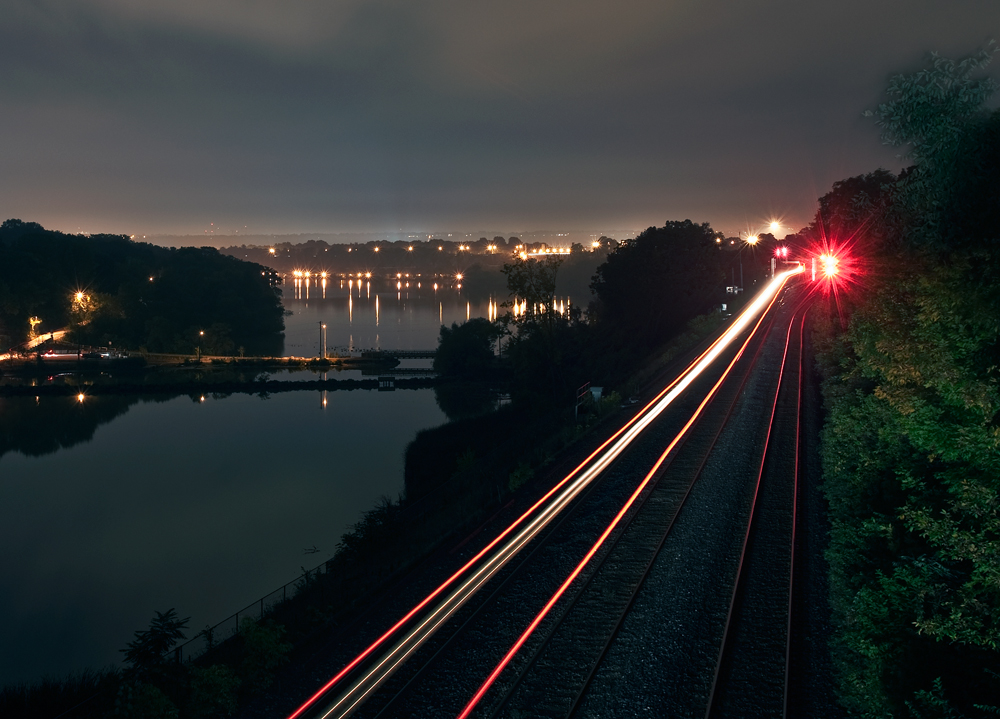 After meeting an NS Detour train at Snake, CN 903\'s DPU marker and dim headlight snakes through Bayview for the trip to Niagara Falls.