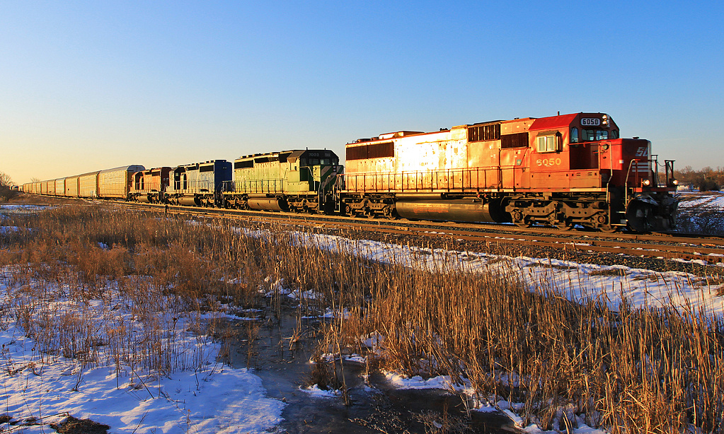 SOO 6057 leads a quartet of EMD power through the South Switch at Smithville just as the sun begins to rise.