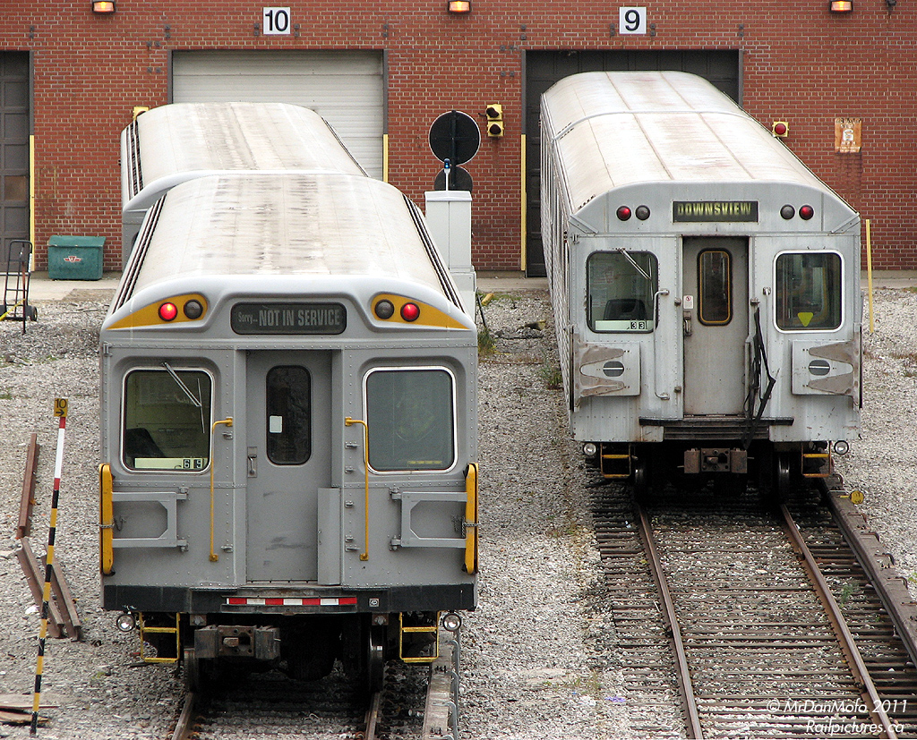 TTC RT-65, a venerable Hawker Siddeley H4 maintenance or \"work car\" retired from revenue service, sits in front of Davisville shops with a slightly younger H5 that\'s still in the game..