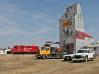CP 3106 two hi-rail trucks and one ford ranger parked as crews try to re-rail a derail hopper car.