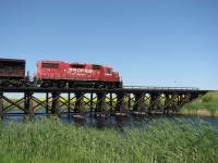 CP 3024 with long time friend Edmunds on running his power lite back to Brandon as it crosses the small bridge near Redvers.