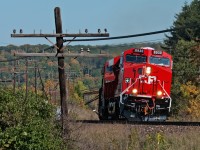 A westbound Canadian Pacific train is mid way through it's assault on the hill with a brand new fresh out of Erie ES44AC in the lead.
