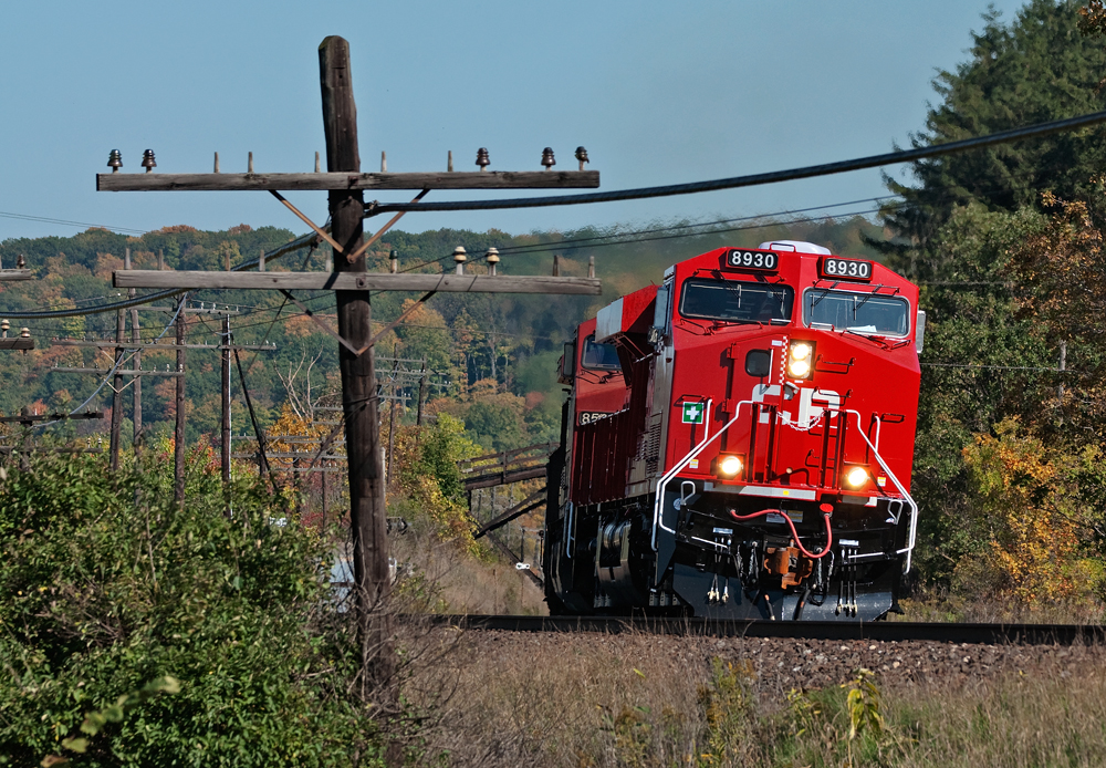 A westbound Canadian Pacific train is mid way through it\'s assault on the hill with a brand new fresh out of Erie ES44AC in the lead.