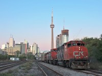 With the sun below the horizon but still caressing the Toronto skyline, we wait for the inbound GO train to Union Station to clear before heading west onto the Oakville Sub with 7,817 ft of train behind a retro consist to Oakville Yard. 