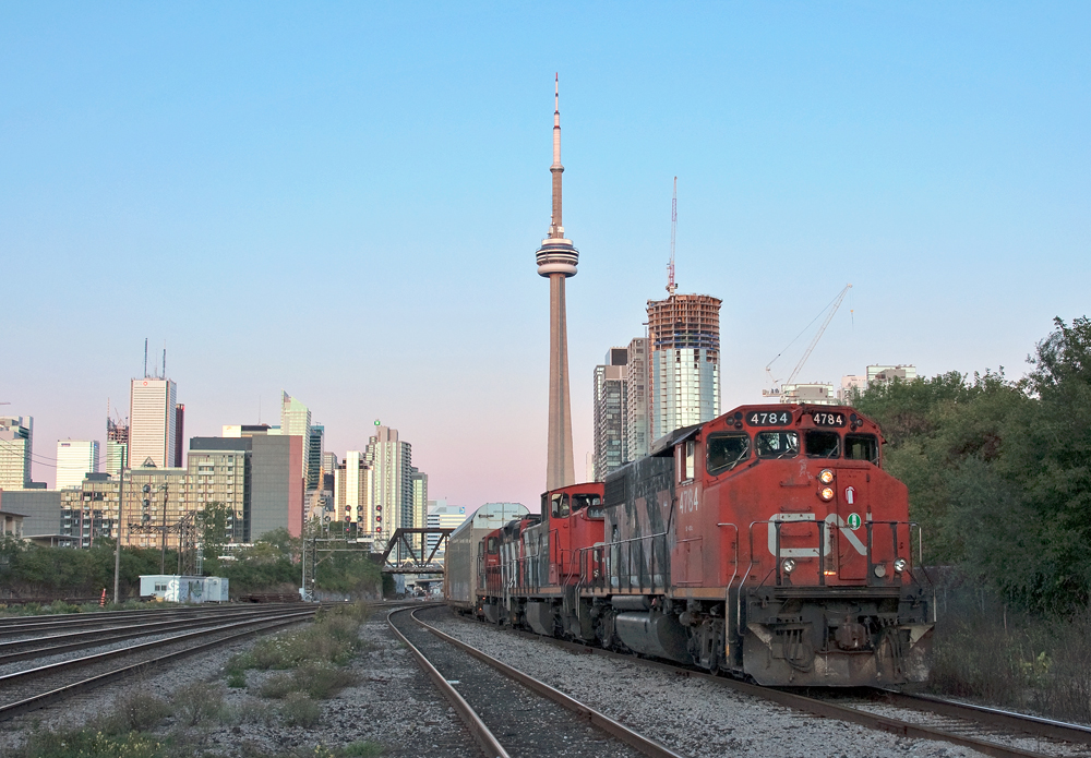With the sun below the horizon but still caressing the Toronto skyline, we wait for the inbound GO train to Union Station to clear before heading west onto the Oakville Sub with 7,817 ft of train behind a retro consist to Oakville Yard.