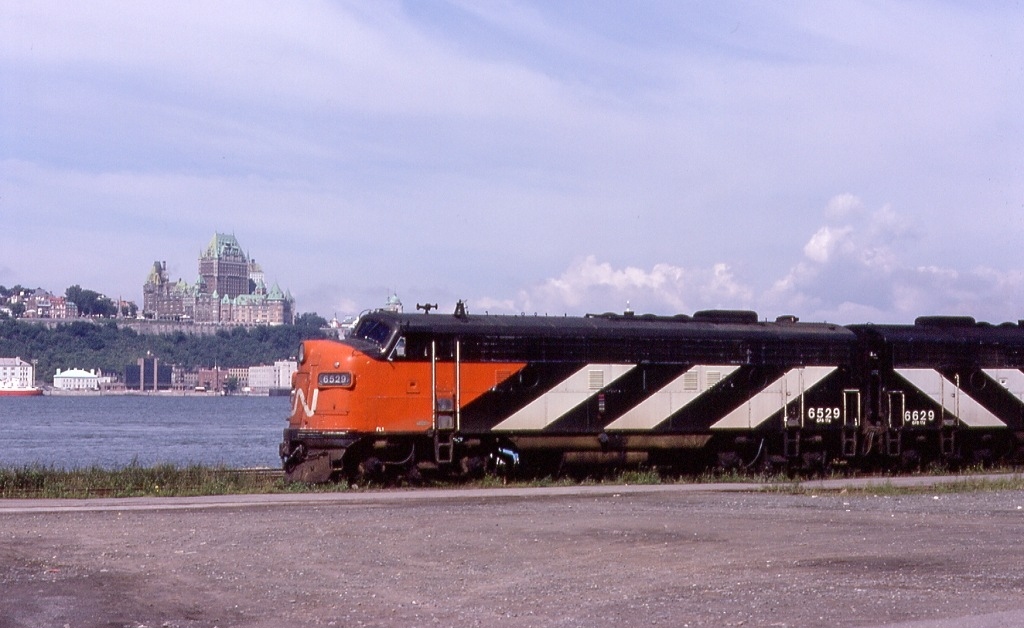 CN #11 makes it\'s station stop at Levis, with Quebec City\'s Chateau Frontenac across the St Lawrence River