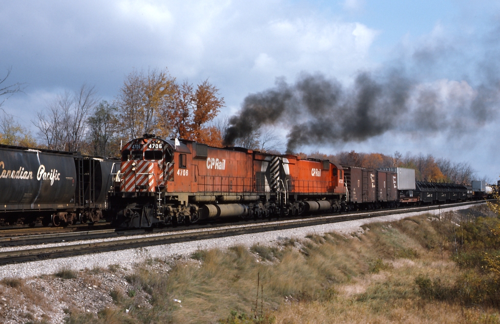 Extra 4706 West, puts on a show as only an MLW could, as it departs Guelph Jct.