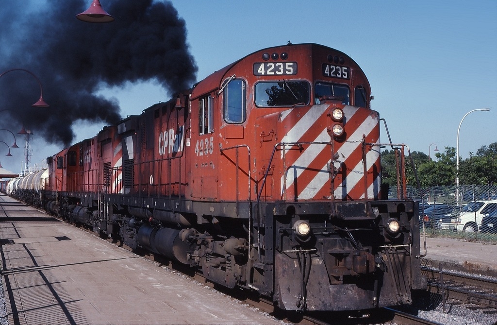 A trio of MLW\'s are in charge of CP 906 as they depart Beaconsfield after setting out a hotbox