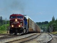 A hot humid mid-day as CP 9701 assisted by CEFX3181 crests the grade (Niagara Escarpment) at Guelph Junction