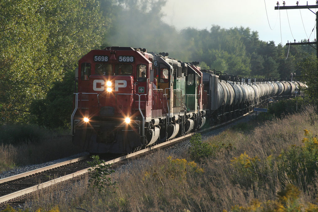 An eastbound CP ethanol train heads through Ayr with leaser locomotives trailing the lead unit, CP 5698.
