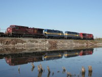 An eastbound CP intermodal cruises along the causeway at Mountsberg Dam with two ICE units sandwiched between two CP GEs.