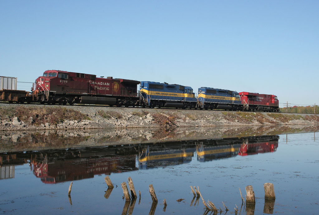 An eastbound CP intermodal cruises along the causeway at Mountsberg Dam with two ICE units sandwiched between two CP GEs.