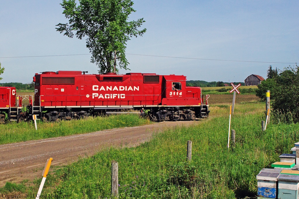 On the edge of Pickerings vast expanse known as the Airport lands a political boondoggle from 1972.3114 is passing one of a handful of operating farms and also to the right a bee farming operation.