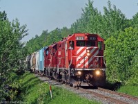 Climbing up the grade on a very tight section of the Sub at Duffins Creek,3133 is leading the longest train of the year 62 cars.The old Soo labelled cars used for many years are being replaced by CEFX  and others and a stock pile was needed.