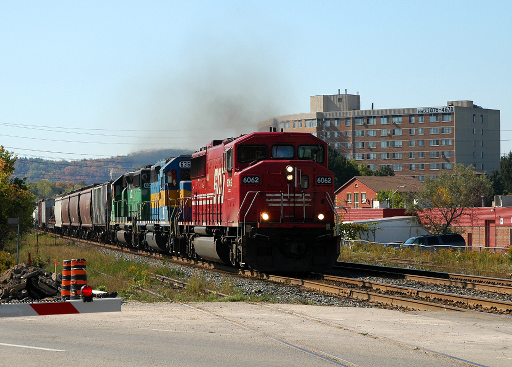 242 crossing Main Street behind SOO 6062 - DME 6364 - HLCX 6299