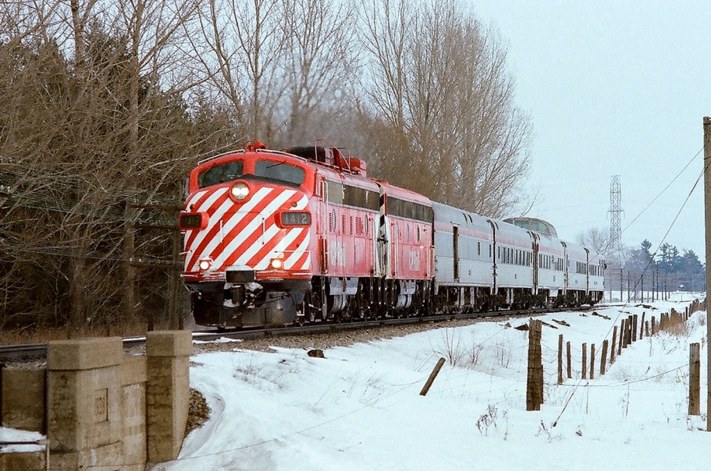 CCP Rail train #11, the Toronto section of \'The Canadian\' at track speed approaching Kleinburg, March 1978. Consist and power typical for the \'off season\'. Within weeks of this negative exposure Train #11 will be \'Via\'ized\'. For the time being, enjoy. Kodak Kodacolor II negative film, transported by a Nikon Nikkormat EL.