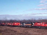 The typical Belleville sub "zowie" lash-up of the era consisting of two C-424s, two M-636s and three rent-a-wreck leasers, is seen near Elliott Road, Newtonville (MP 151) with the 4235 in the lead. I leave as an exercise for the viewer to determine which unit is responsible for the puff of smoke stage left. 