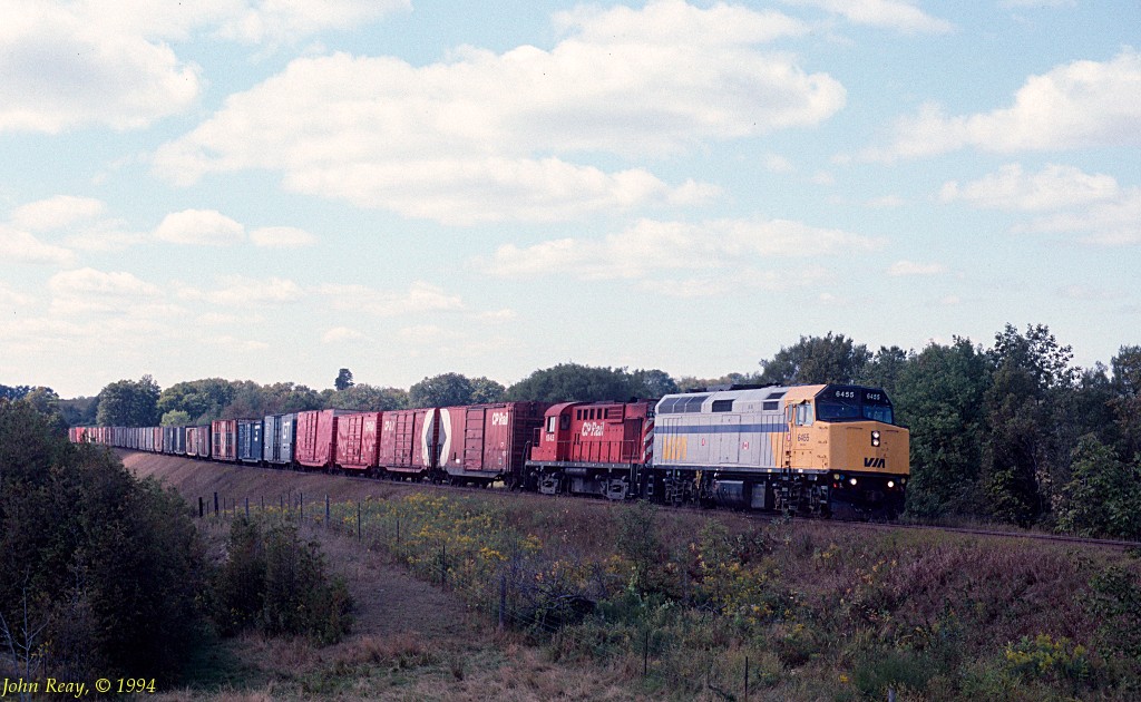VIA F40PH-2 #6455 leads a CP MLW RS-18u on an eastbound freight near milepost 151 CP Belleville sub (Elliott Road, Newtonville) in October 1994