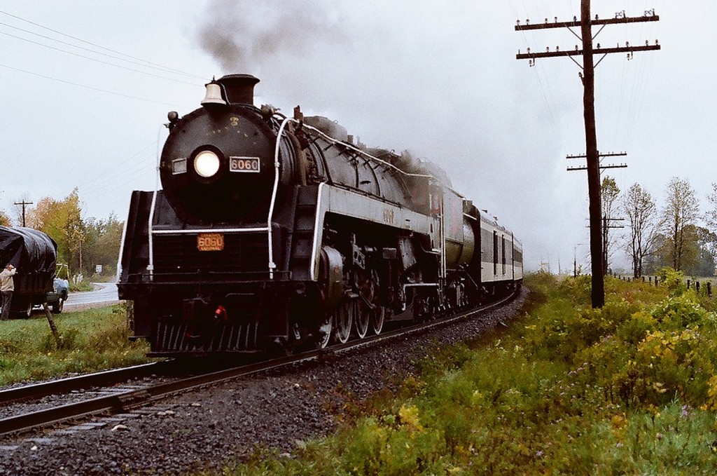 A Lefroy, Ontario resident admires the sound and sight of  CNR Mountain Type #6060 at track speed on the CN Newmarket Subdivision on this rainy September 1977 Saturday morning. Kodak Kodacolor II ASA100  negative transported by a Nikon Nikkormat EL. Photographer S. Danko.