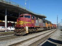 SD75M 8253, SD70MAC 8880, and Dash 9-44CW 985 travel through New Westminster.