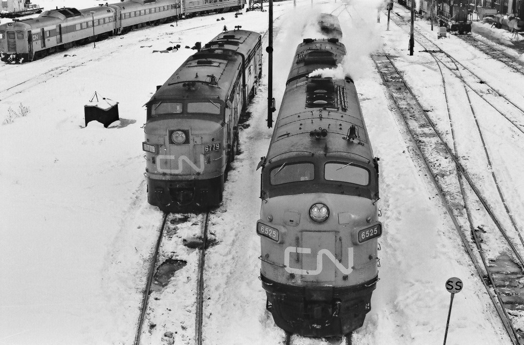 Cab Units: A contrast between the MLW FPA-4 and GMD FP-9A at  a \'Via free\' CN Spadina on this  February 1976 snowy Saturday. Kodak Tri X Pan b&w negative film transported by a Nikkormat. Photographer S.Danko.