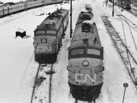 Cab Units: A contrast between the MLW FPA-4 and GMD FP-9A at  a 'Via free' CN Spadina on this  February 1976 snowy Saturday. Kodak Tri X Pan b&w negative film transported by a Nikkormat. Photographer S.Danko.