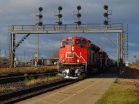 CN 148 led by CN 8859, 2225, 2702 & IC 1010 passes the signal bridge at the Sarnia VIA platforn after coming thru the tunnel from Port Huron.