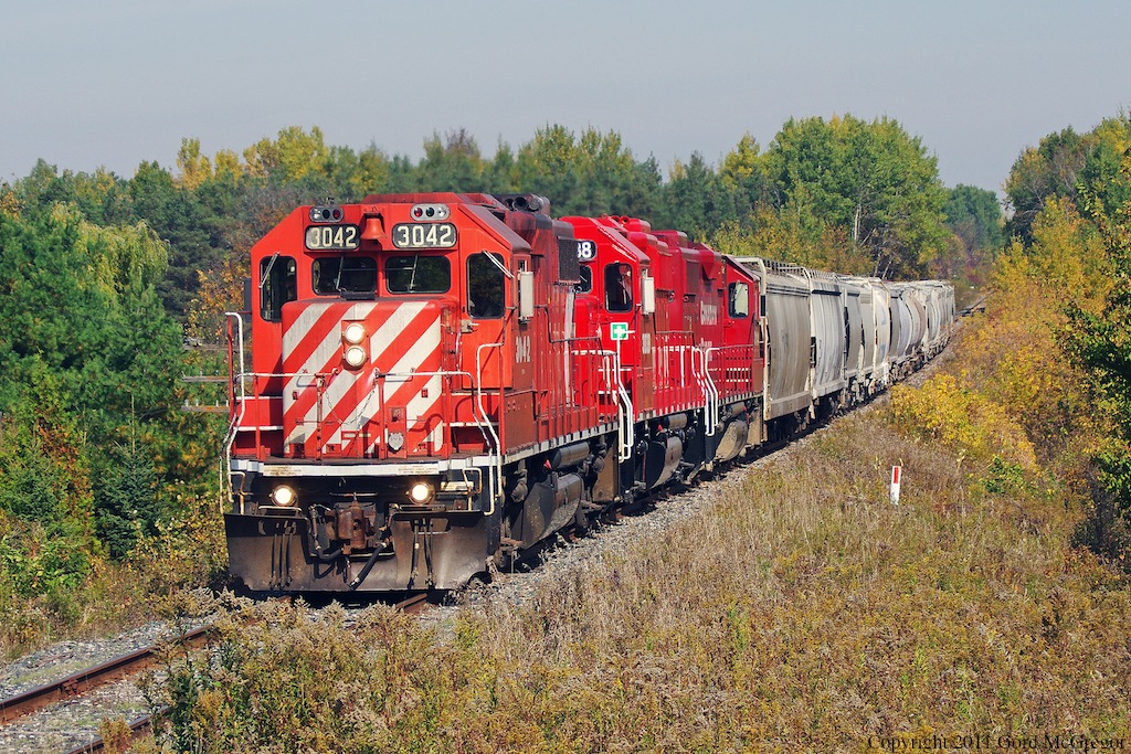 3042 leads a small train of 12 cars up the grade at Green River Ontario.