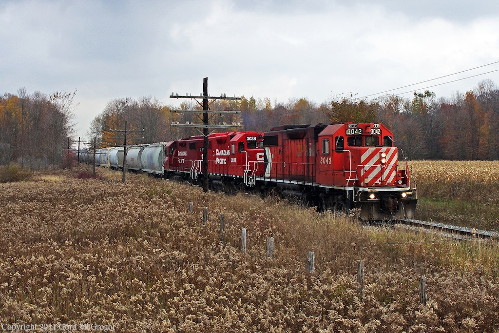 The current Havelock consist in red different reds blends with the browns and oranges of mid fall.Todays payload of 26 cars is headed to the Toronto Yard a 45min snail pace away,and then a return to Havelock as T08 with a load of mostly empties.A very long day by any standard.