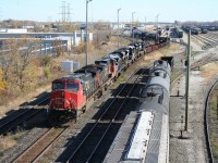 As a yard job works on a cut of cars on the adjacent lead, CN 385 begins its pull past the the US Customs inspection as it makes its move for the St Clair Tunnel and the crossing into the United States. In tow directly behind the power today is a quartet of shiny new SD70ACe locomotives for Norfolk Southern, fresh from the EMD factory in London.