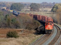 I need a 100-400 lens now... Here, the import stack train from Montreal Wharf, PQ - Toronto BIT, ON and finally onto Chicago Markham, IL makes its way through Newtonville while VIA 57 overtakes (look after the block of yellow MSC in the single tank tainers for a headlight. 