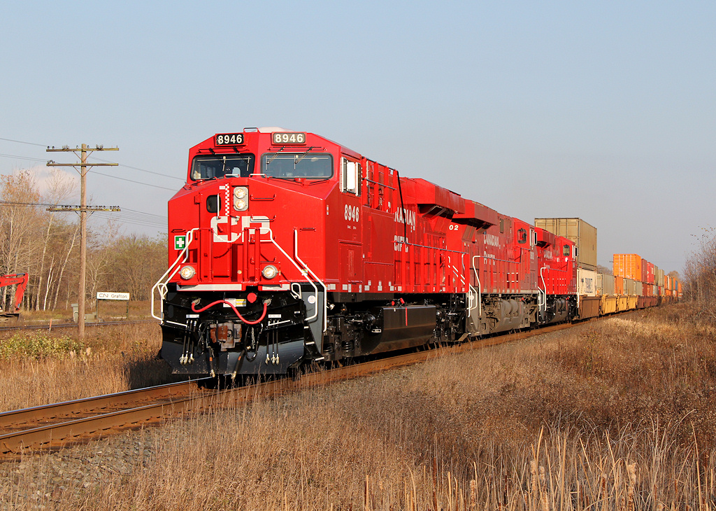 CP 115-01 speeds through mile 127 of the CP Belleville Sub adjacent to CN\'s Grafton plant. CP 8946 had just been delivered to CP, and ran east to Montreal prior to a run to Western Canada providing the power for one of CP\'s hotshot trains.