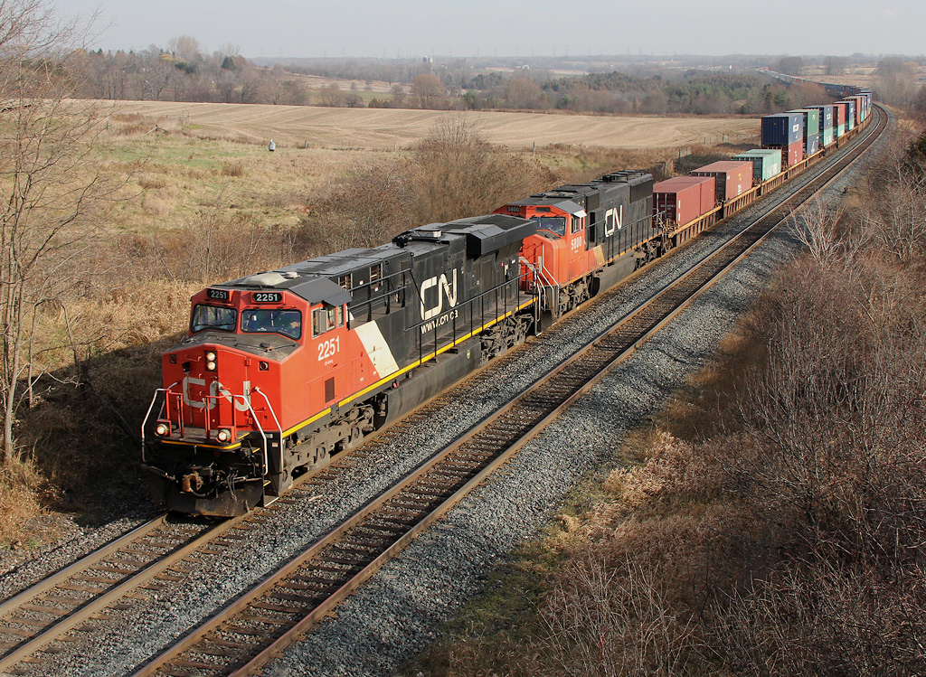 CN 2251 + CN 5800 lead a shorter than normal Q121 through Newtonville, much of the train was block swapped to 149.