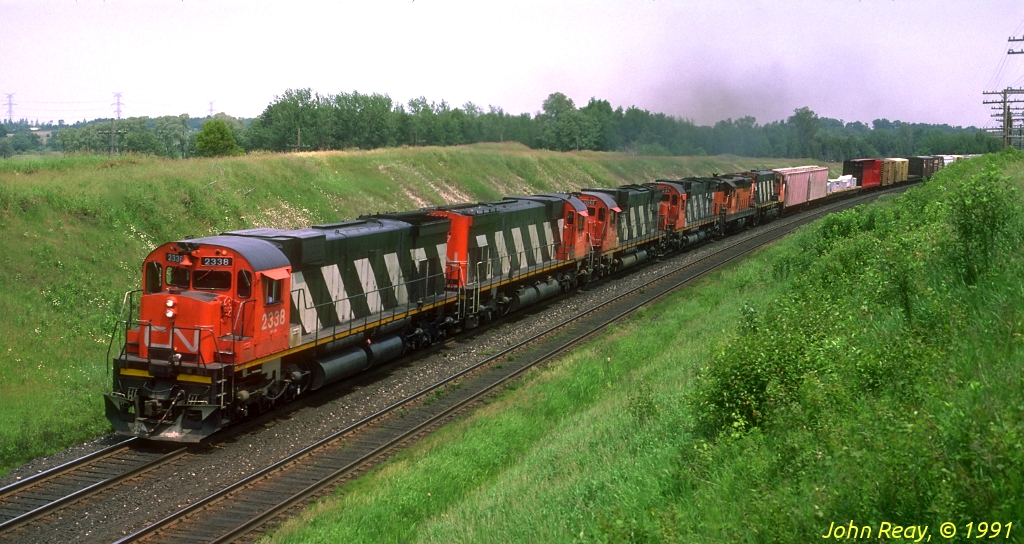 More than a few MLW M-636s and a bonus Bessemer & Lake Erie SD-9 westbound at Nichols Road, Newtonville in July 1991....those were the days