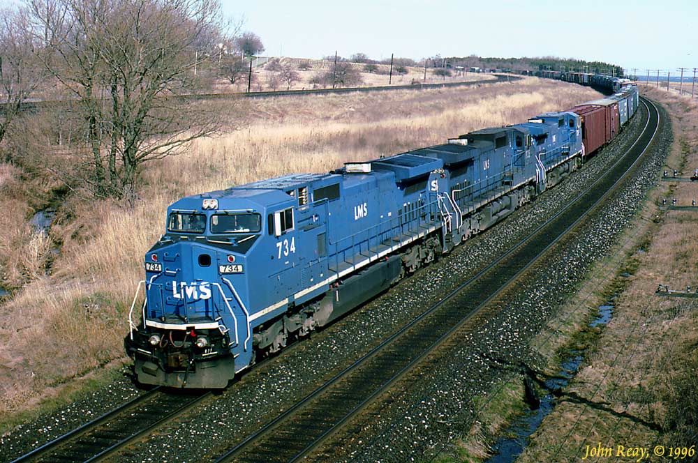 Three almost new LMS leasing Dash 8-40CW\'s roll down grade on the CN Kingston sub at MP 284, adjacent to CP\'s Lovekin siding. As I was staked out waiting for this train I was approached by some \"birders\" who were staking out their own rare bird that had been spotted in the area. I told them I was waiting for three bluebirds to show up. They were quite amused!