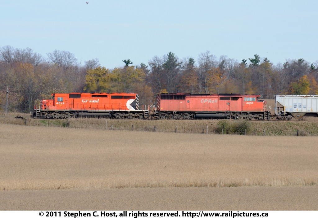 Canadian Pacific 6013 west is rolling by grain fields in Puslinch Township, Ontario with trailiung unit CP SD40-2F 9003 on CP train 441.