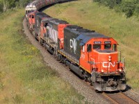 CN 6014 leads a manifest with military vehicles split in the middle along with a collection of EMD power bound from Melville to Symington.