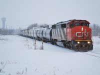 CN 5502 drags 47 cars of mostly empty flats across CP's Wynyard Sub as it makes its way north on the as needed CN Yorkton Sub to the HBRY. 