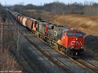 The head end of grain train 874 finds a sucker hole in the cloud cover as they climb through Lovekin. CN 2320 and 5768 lead, while 2247 and 8910 make up the mid train DPU on the 155 car, 22000 tonne train. 1432hrs.