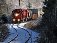 A light dusting of snow that fell overnight is barely disturbed by Kawartha Lakes T07 at Raglan. CP 3114, 3032, and 3111 lead 22 cars west. 1040hrs.