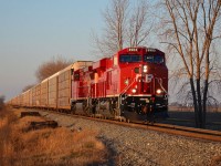 Brand new CP 8903 and ex Unstoppable 9777 lead this long autorack train eastbound in the early morning December sun.