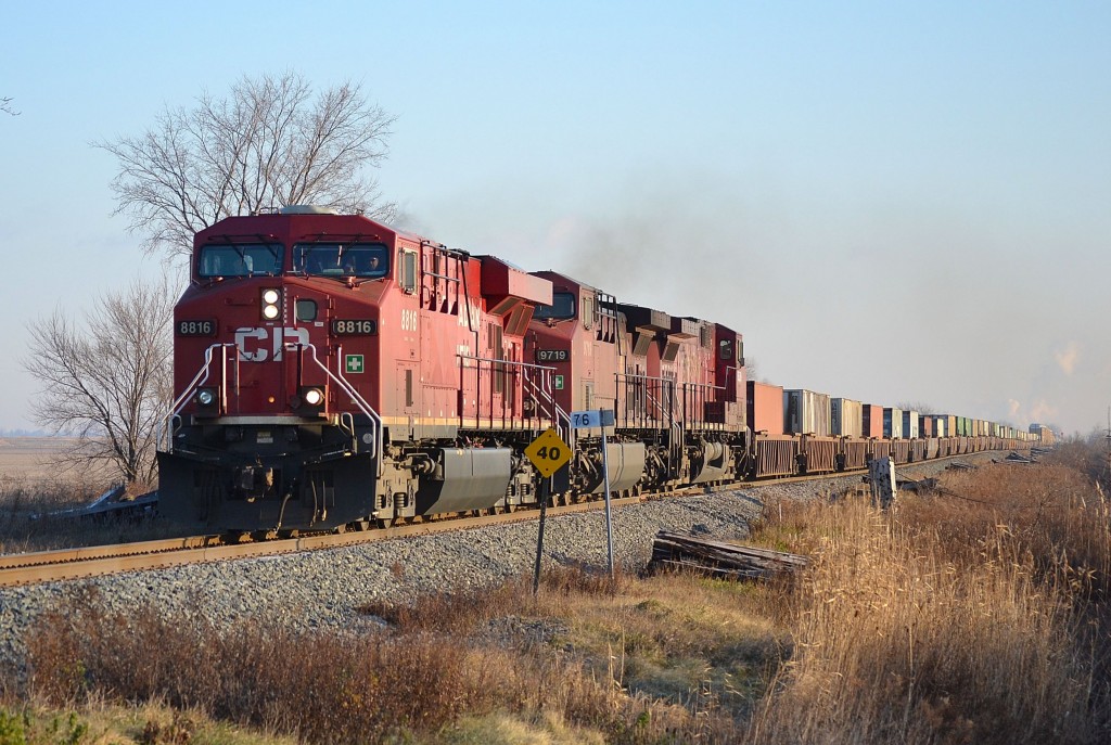 CP 241 led by a trio of GE\'s, heads westbound past mile 76 on a chilly December morning.